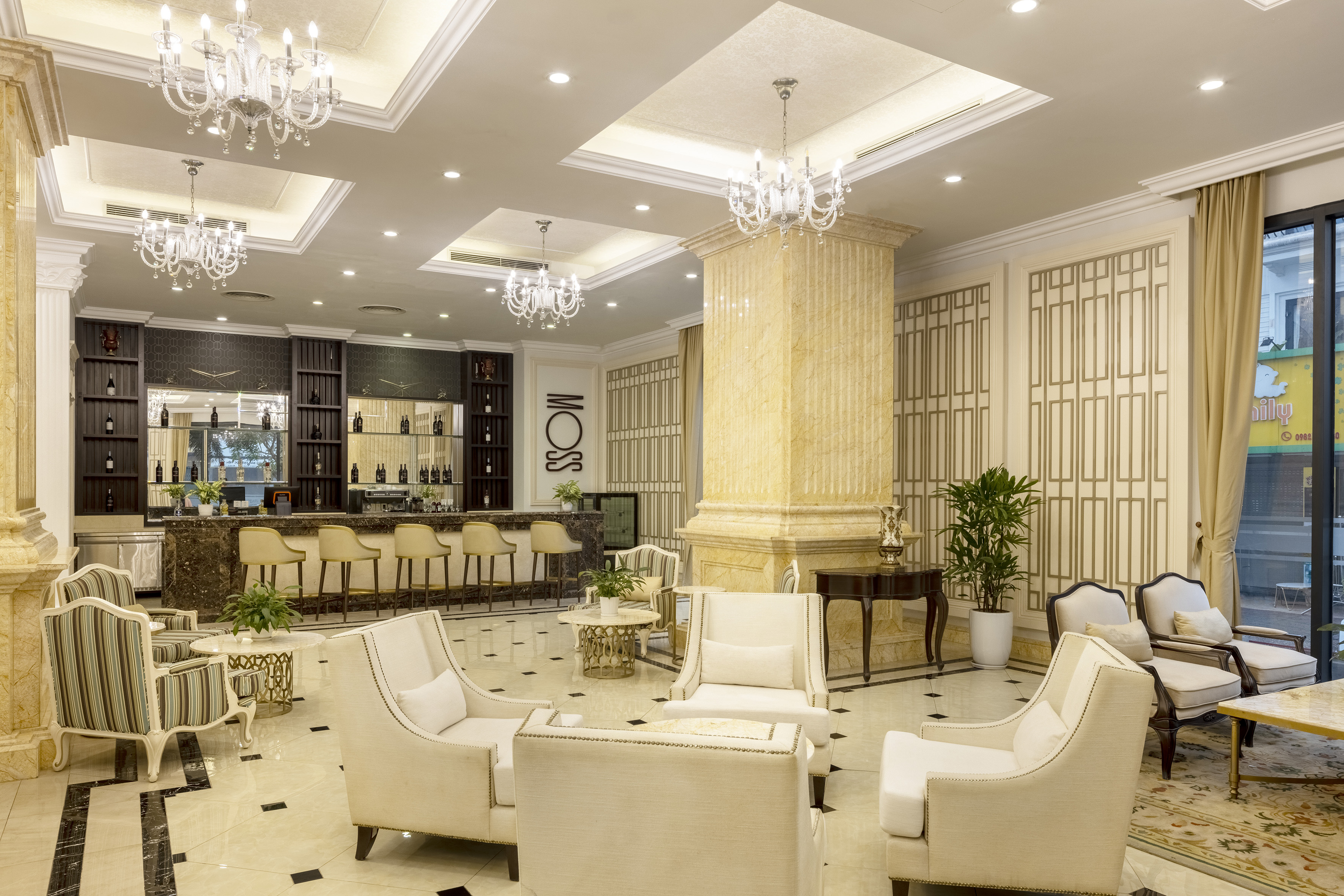 a room with white chairs and a bar