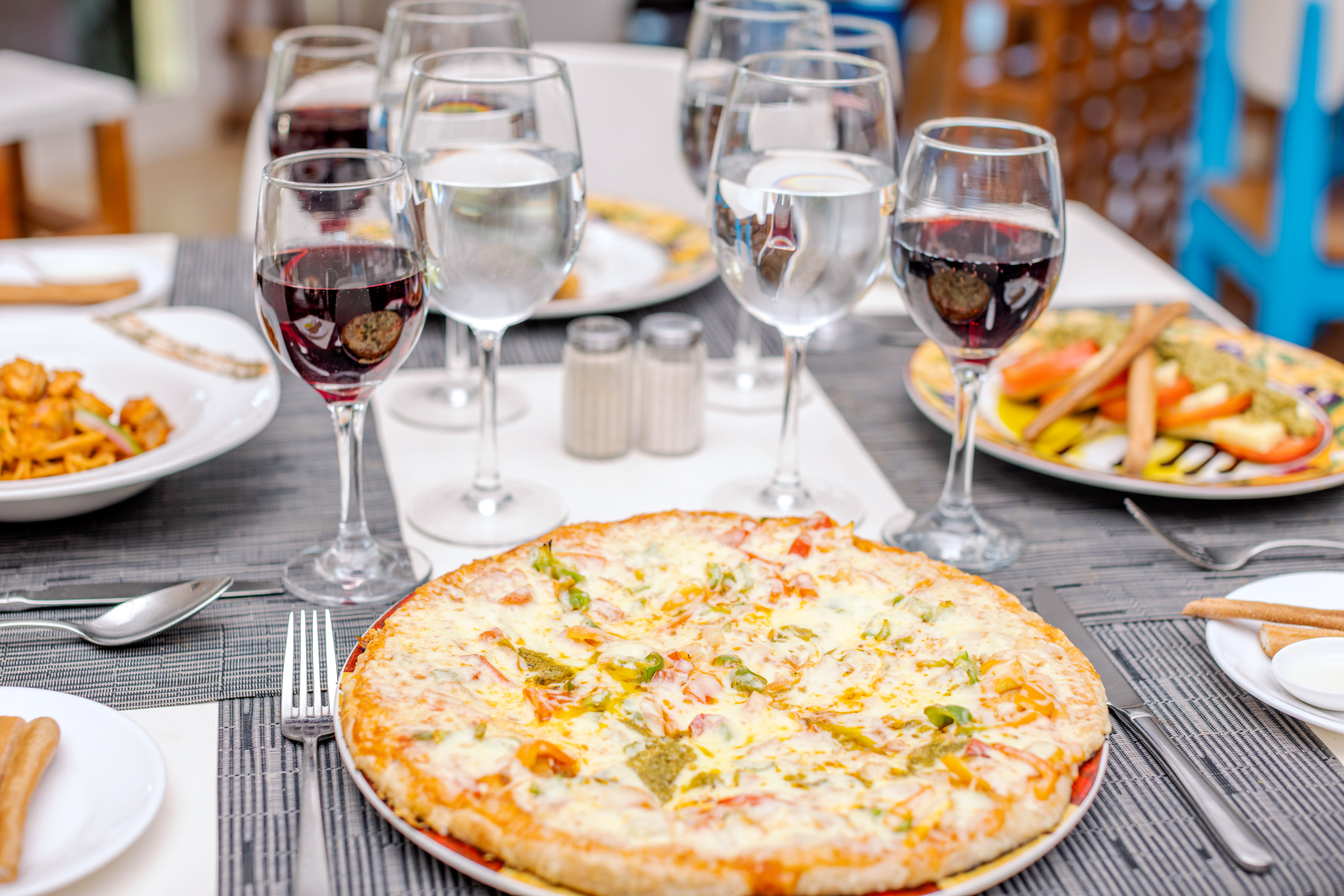 a pizza and wine glasses on a table