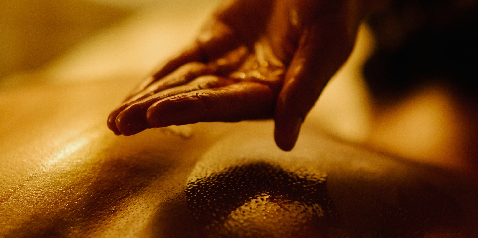 a person's hand over a person's back