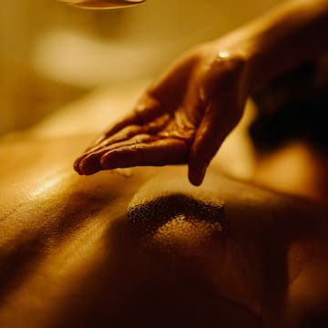 a person's hand over a person's back