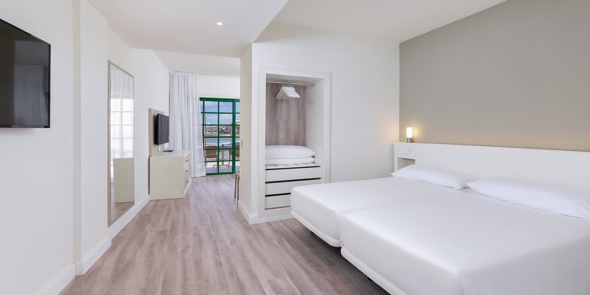 a room with a bed and a television