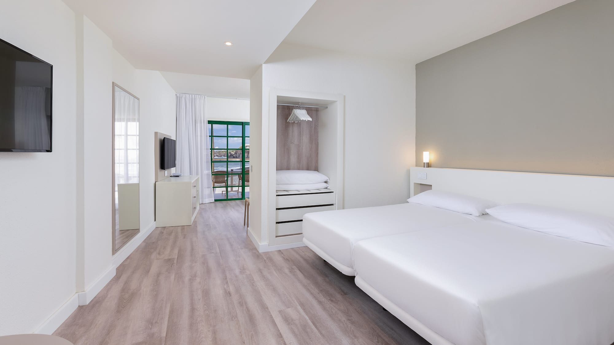 a room with a bed and a television