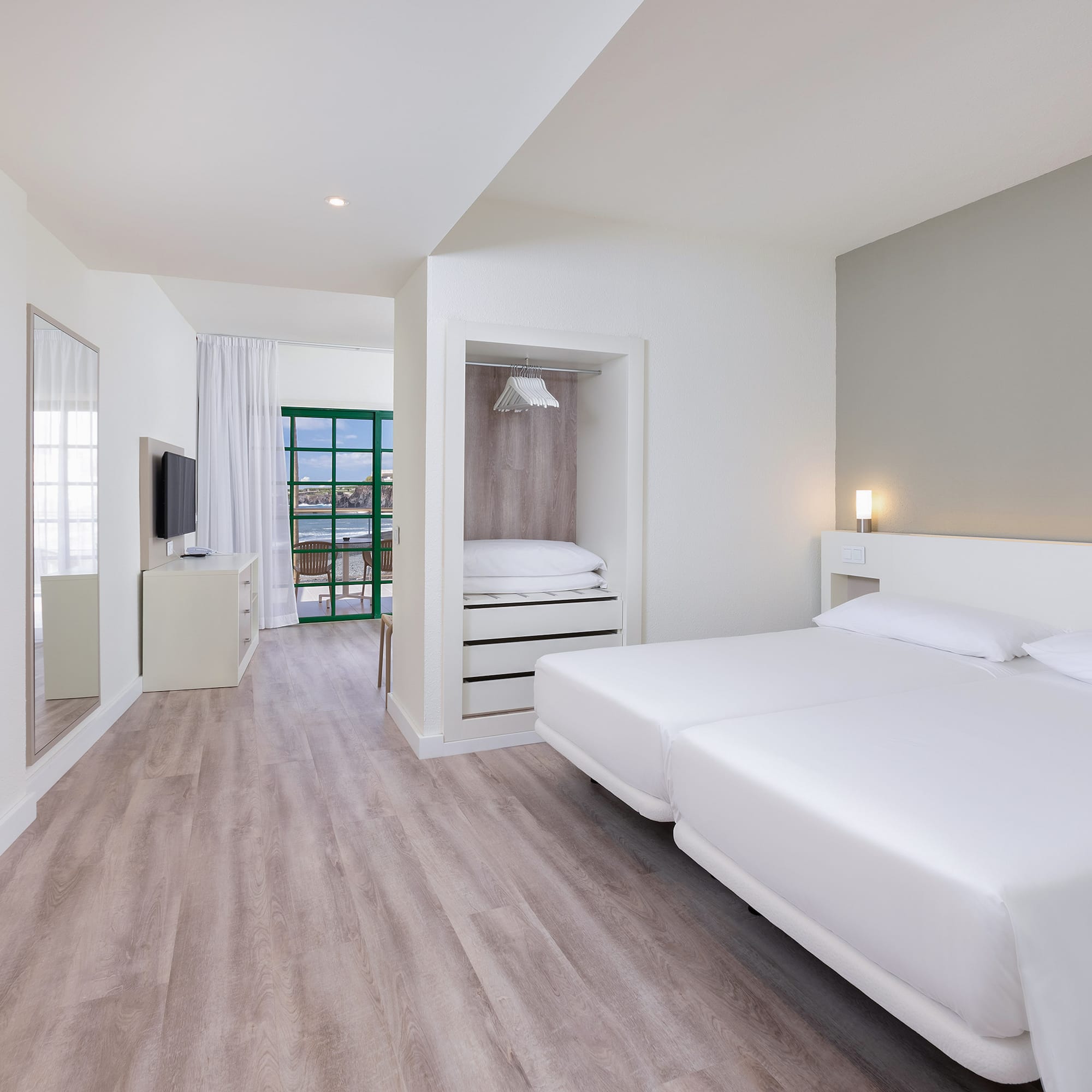 a room with a bed and a television