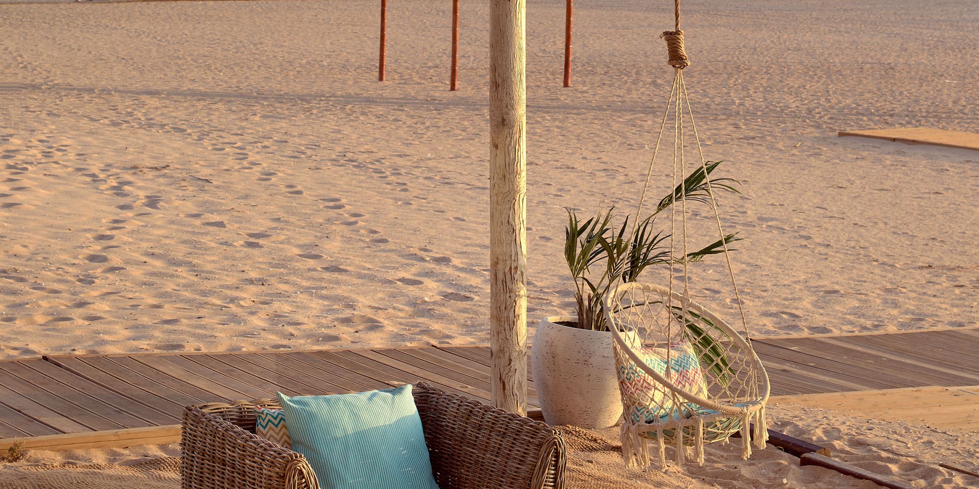 a beach with chairs and a table