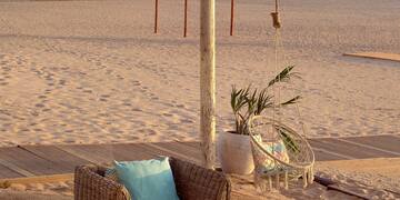 a beach with chairs and a table
