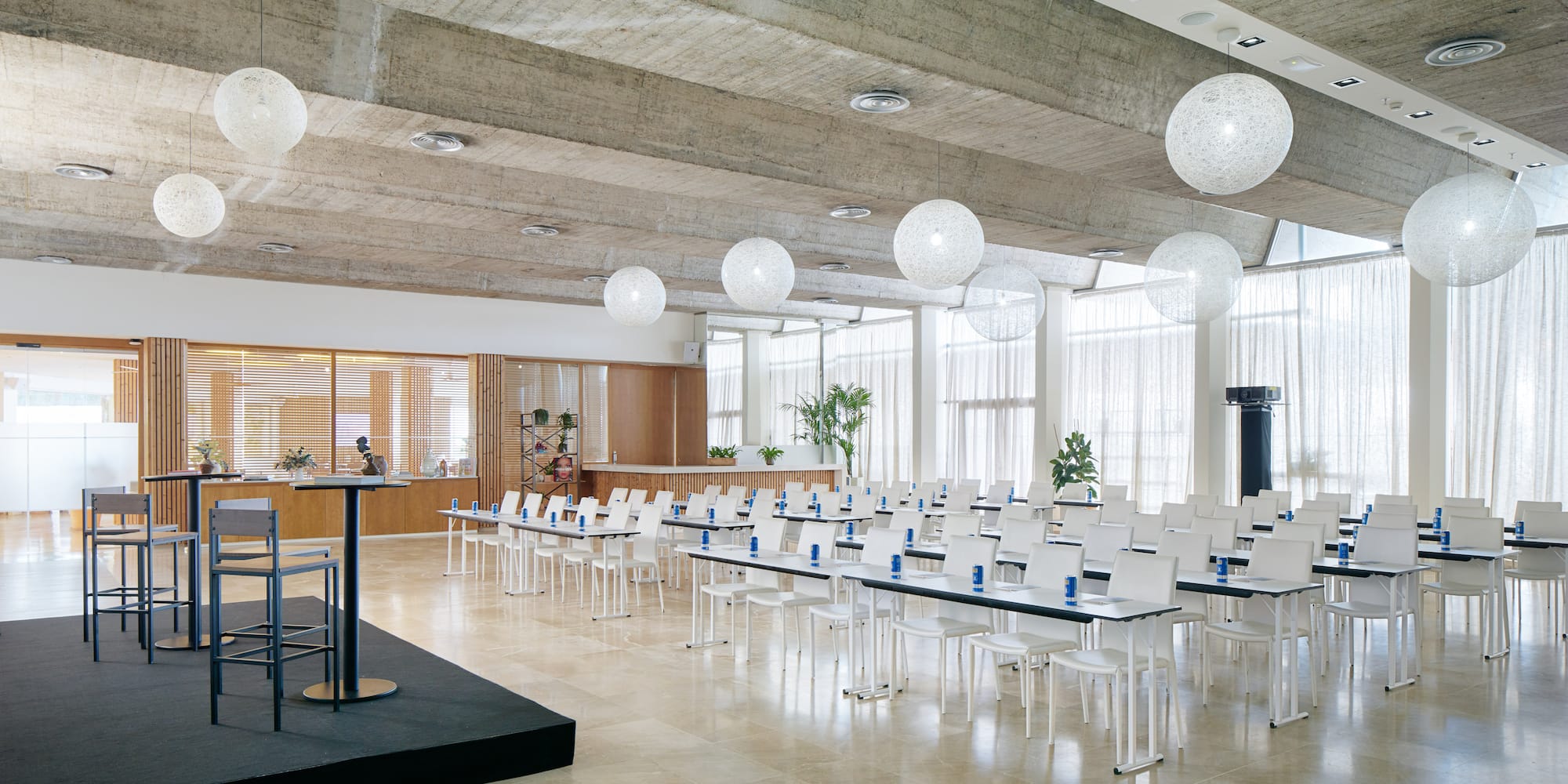 a room with white chairs and a podium