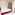 Modern hotel room, red bed, patterned wall, marble floor, en-suite.