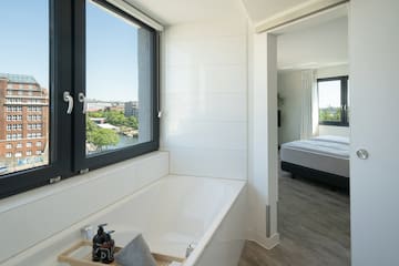 a bathroom with a window and tub