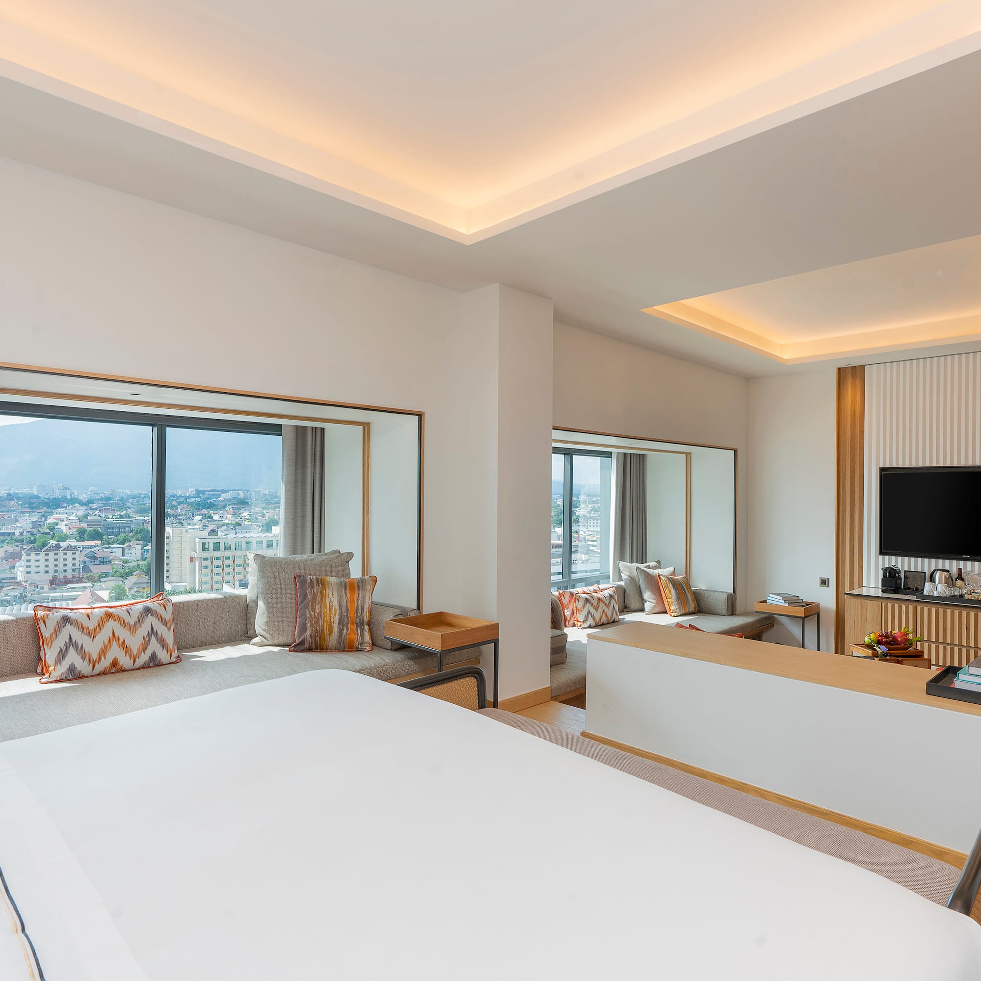 a room with a large bed and a television