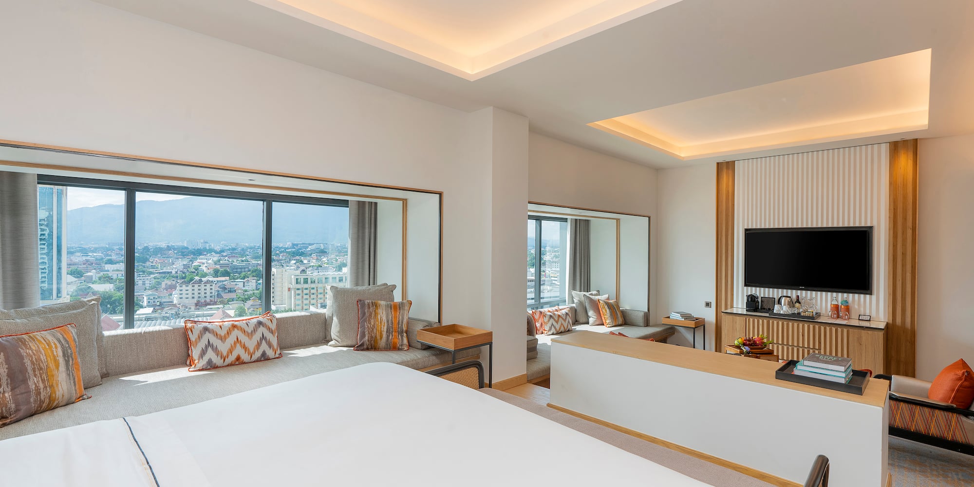 a room with a large bed and a television