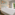 Sol Hotels twin room with modern white beds and window overlooking green trees.