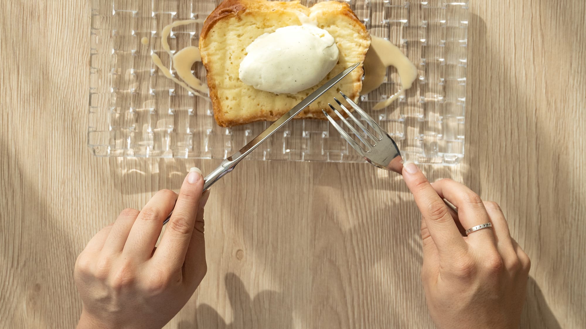 a person eating a piece of bread with butter and a fork