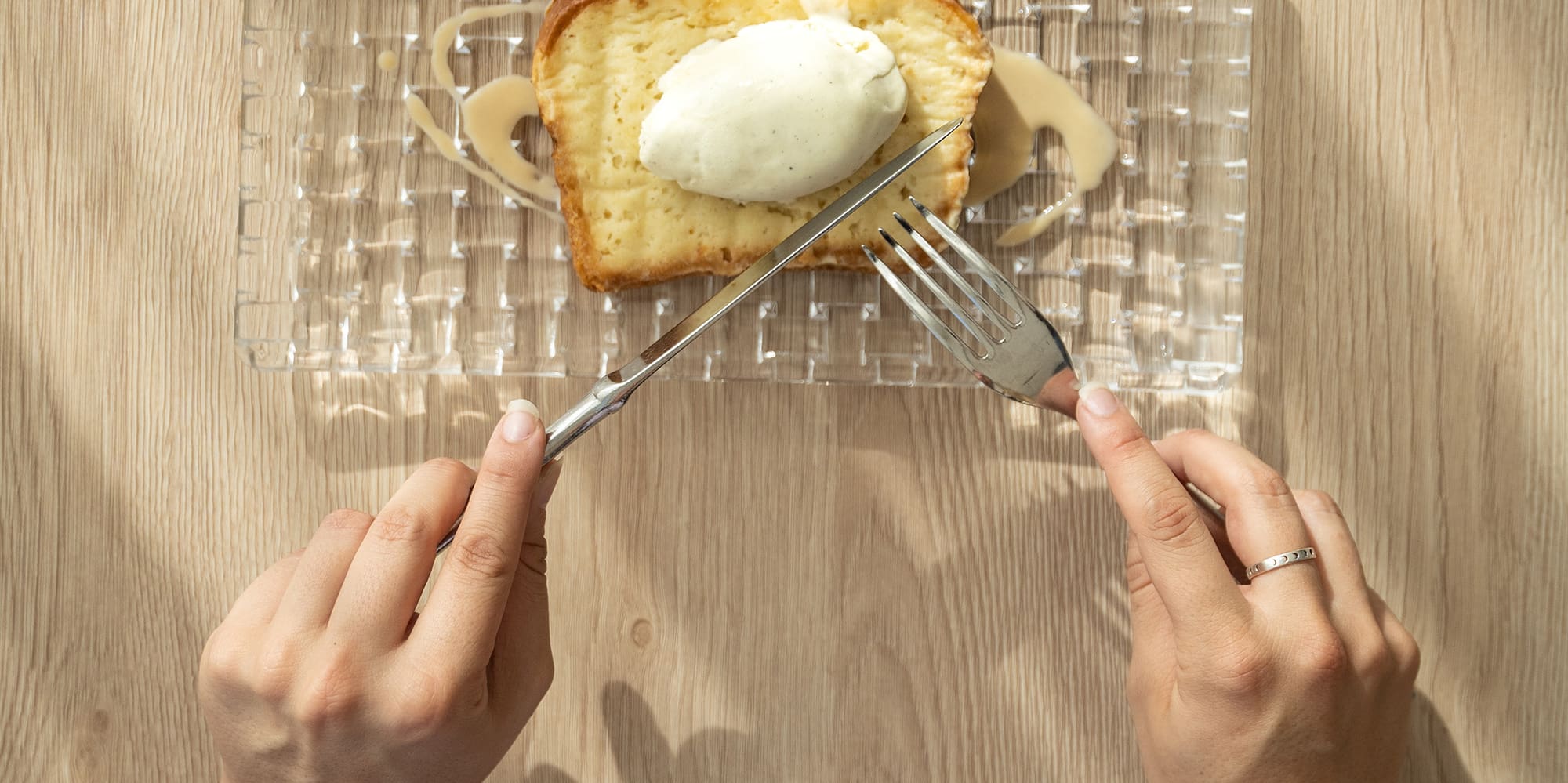 a person eating a piece of bread with butter and a fork