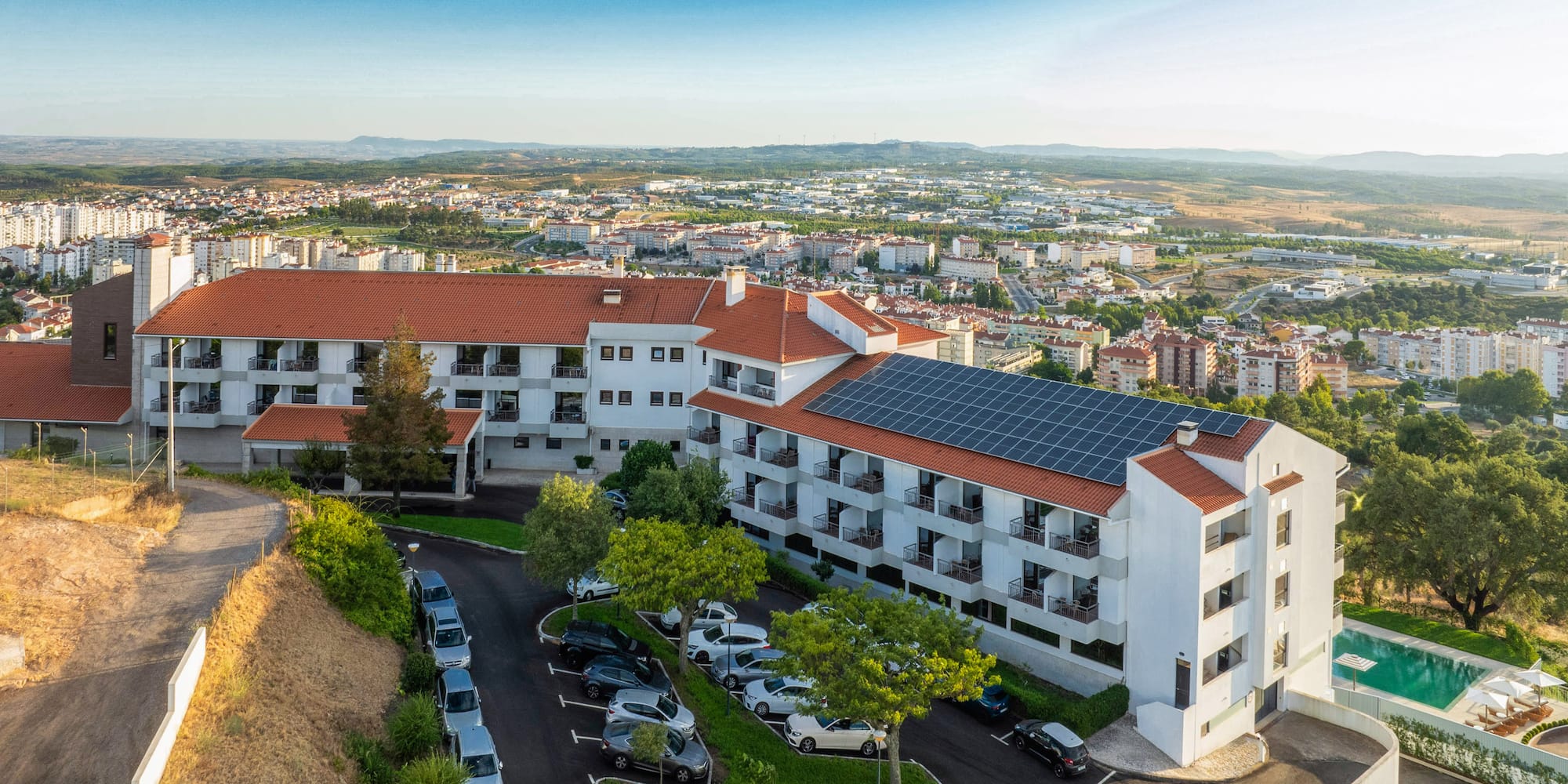 a building with parking lot and cars parked in front of it