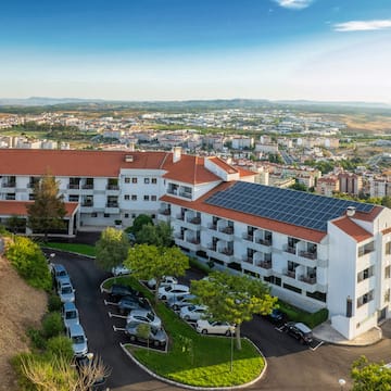 a building with parking lot and cars parked in front of it