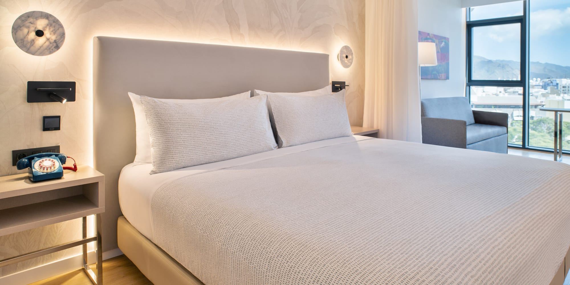 a bed with white sheets and pillows