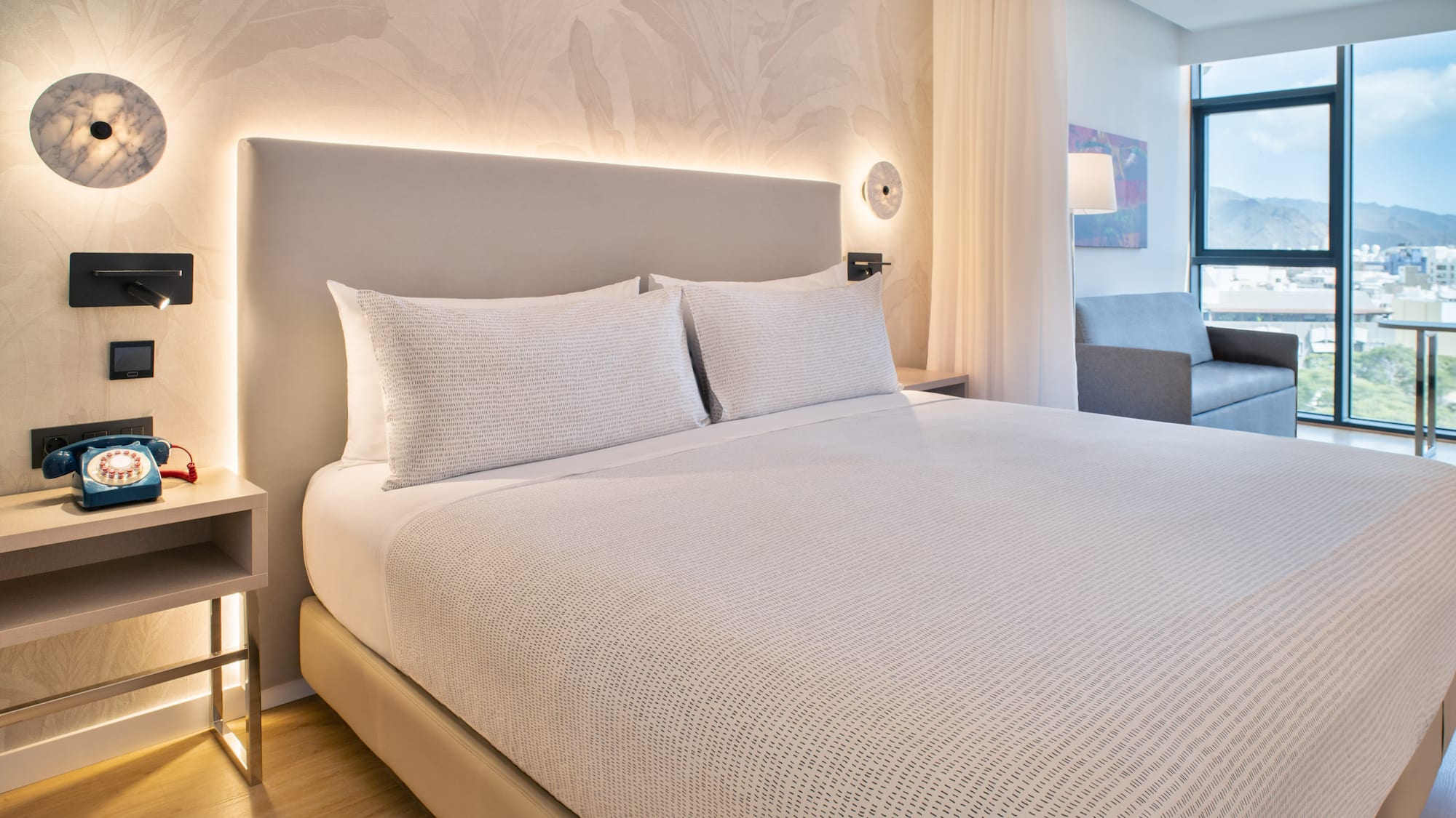 a bed with white sheets and pillows