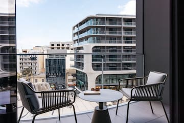 a balcony with chairs and a table