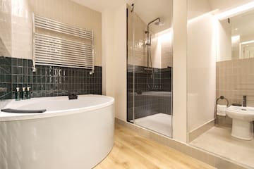 a bathroom with a tub shower and a shower