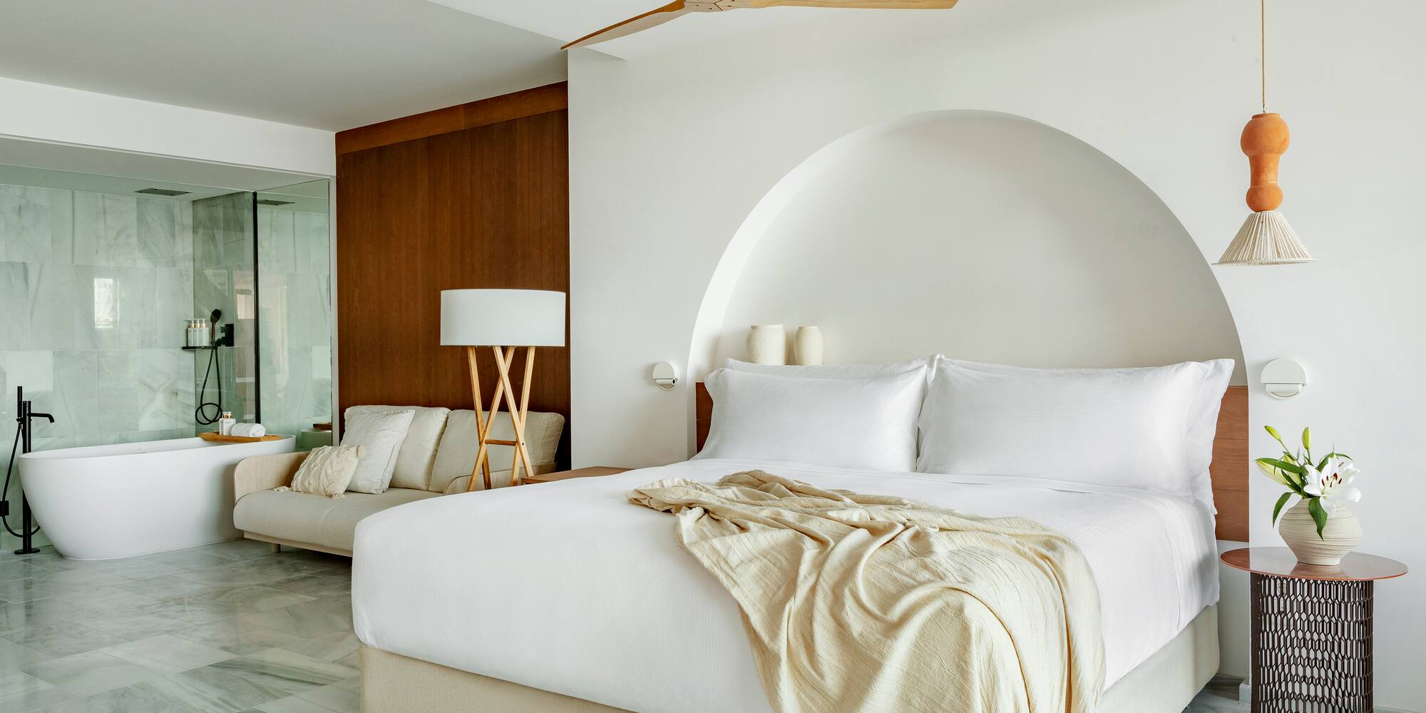 a bed with a fan in a room