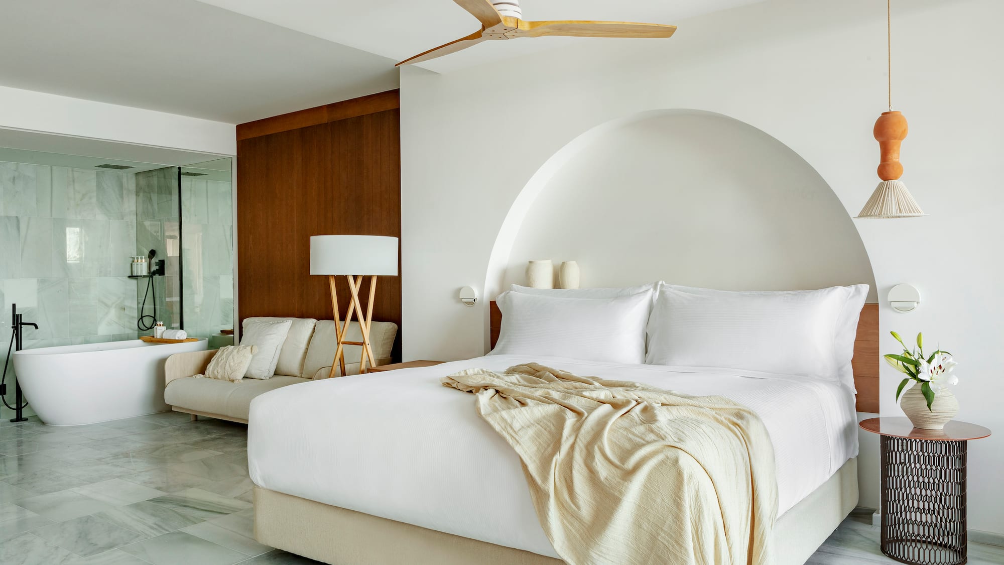 a bed with a fan in a room