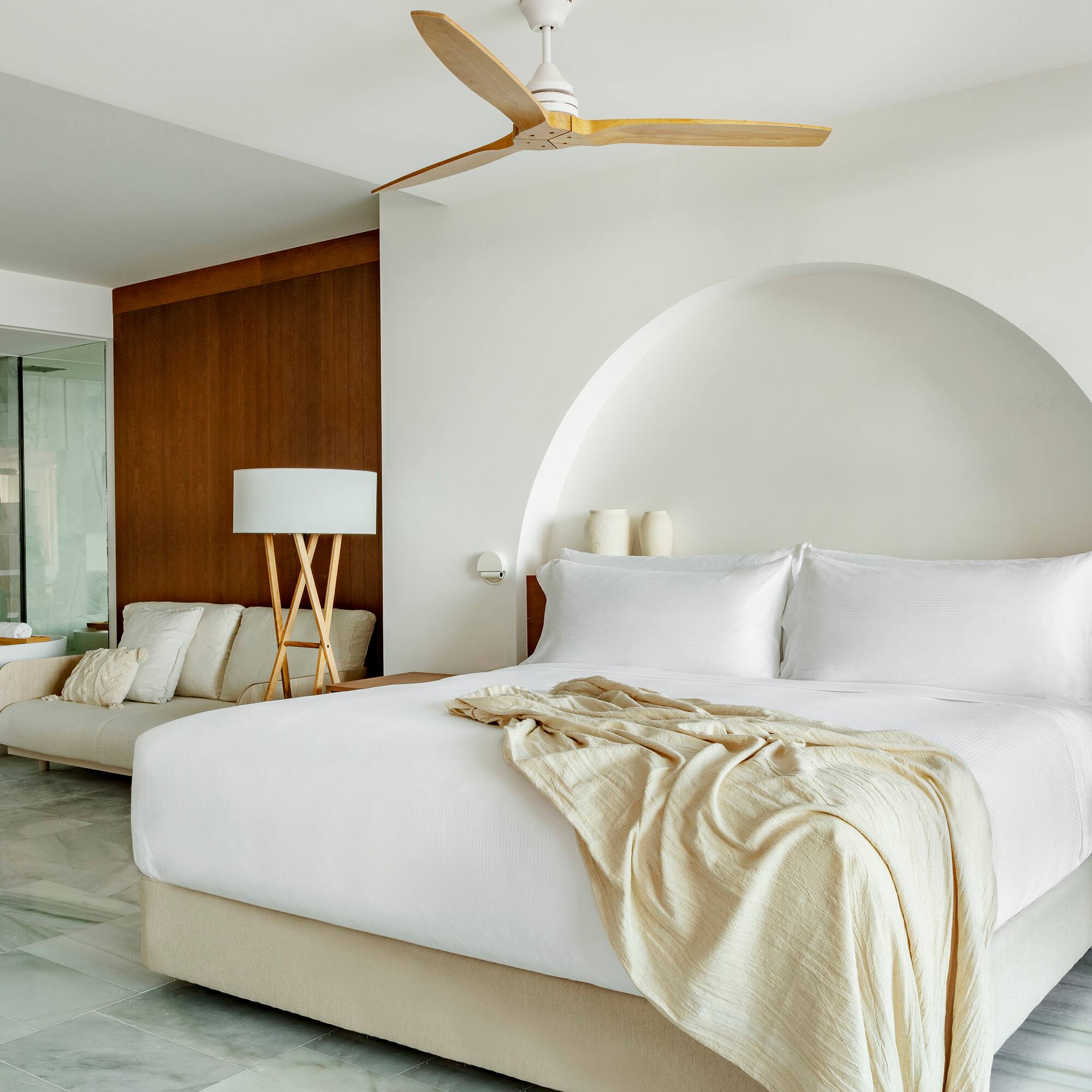 a bed with a fan in a room