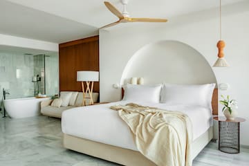 a bed with a fan in a room