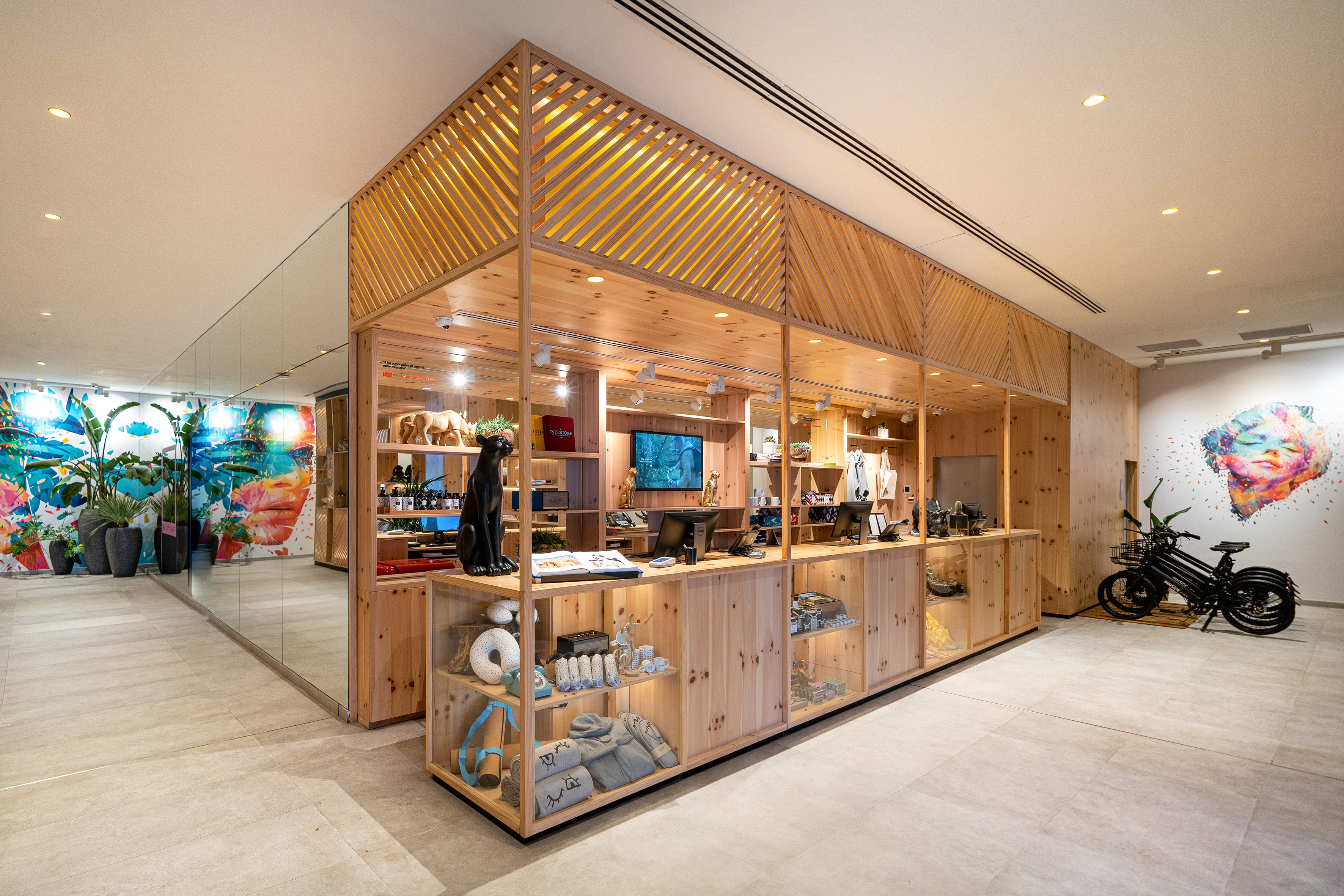Modern retail store with natural wood display, diverse products, and vibrant art.