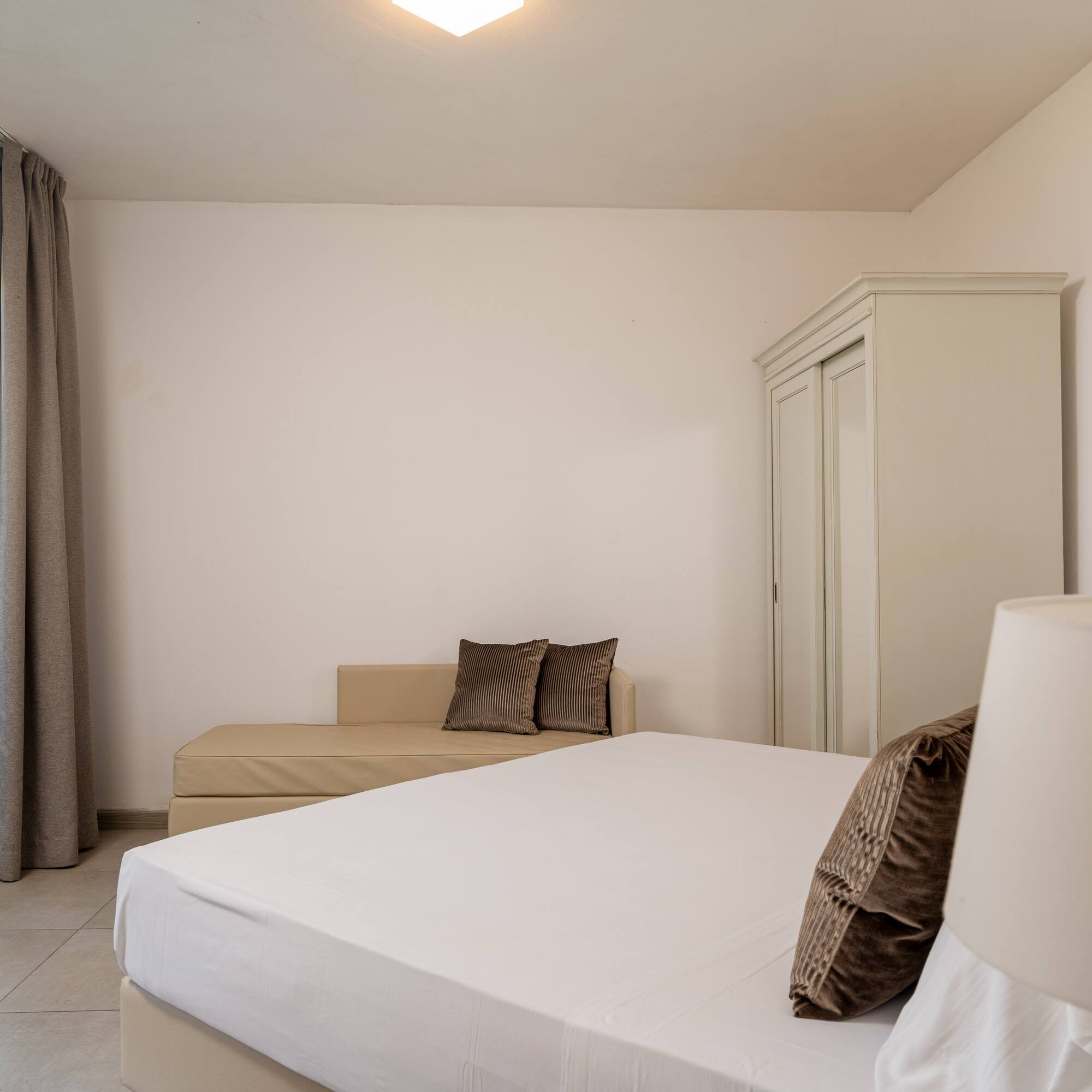 a bedroom with a bed and a couch