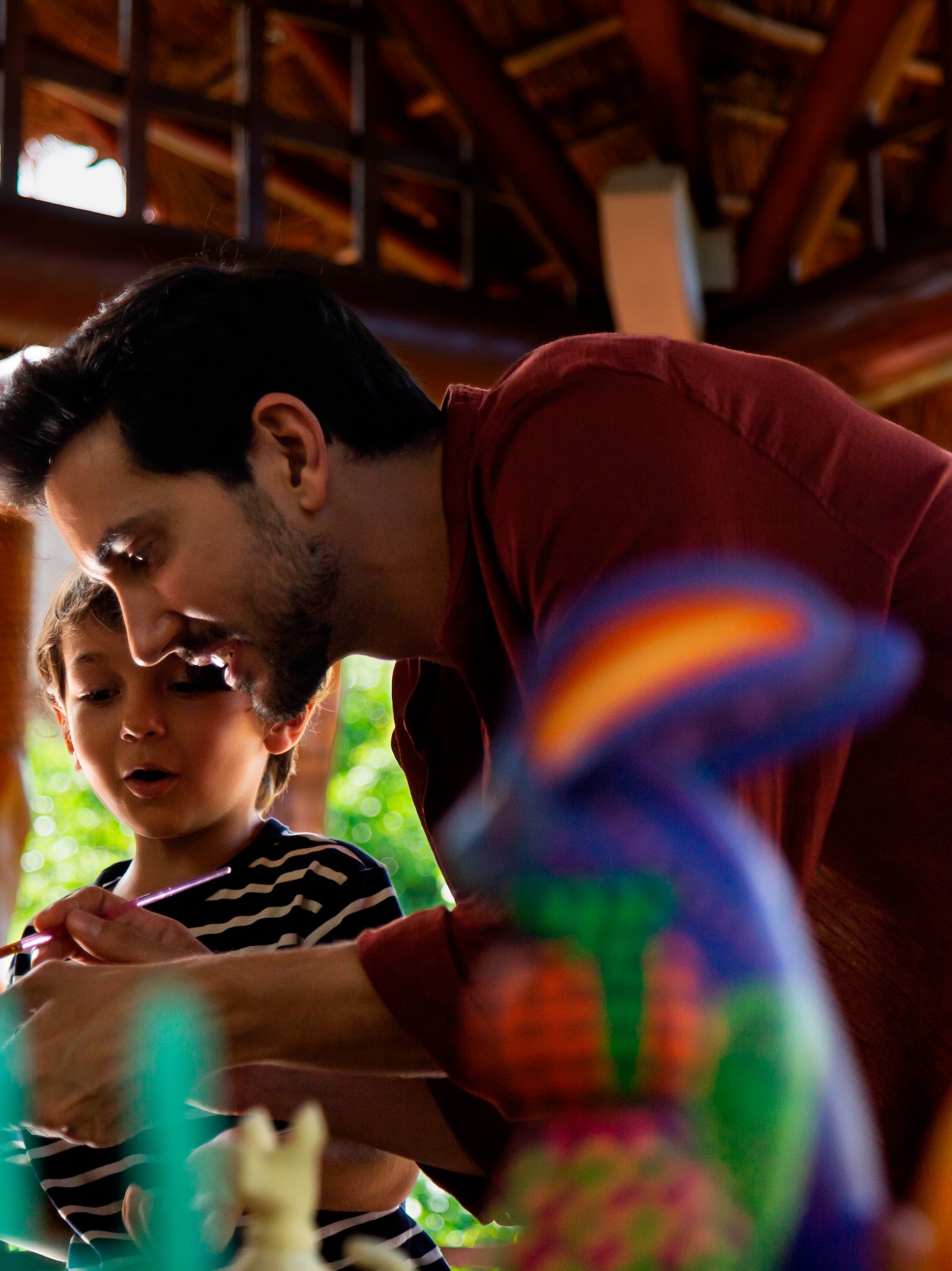 a man and child playing with toys