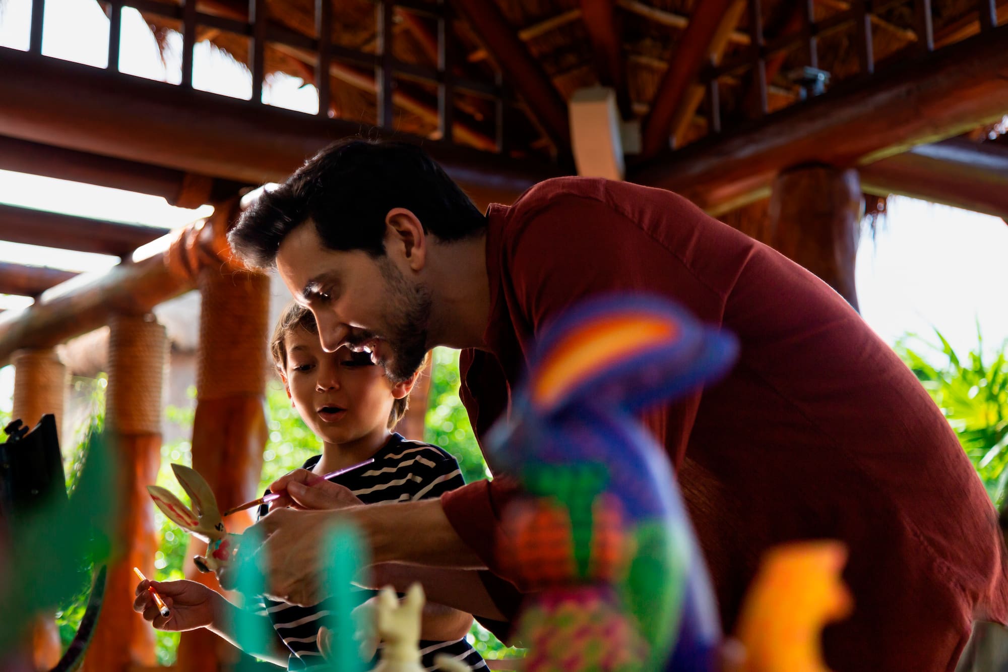 a man and child playing with toys