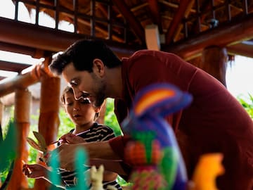 a man and child playing with toys