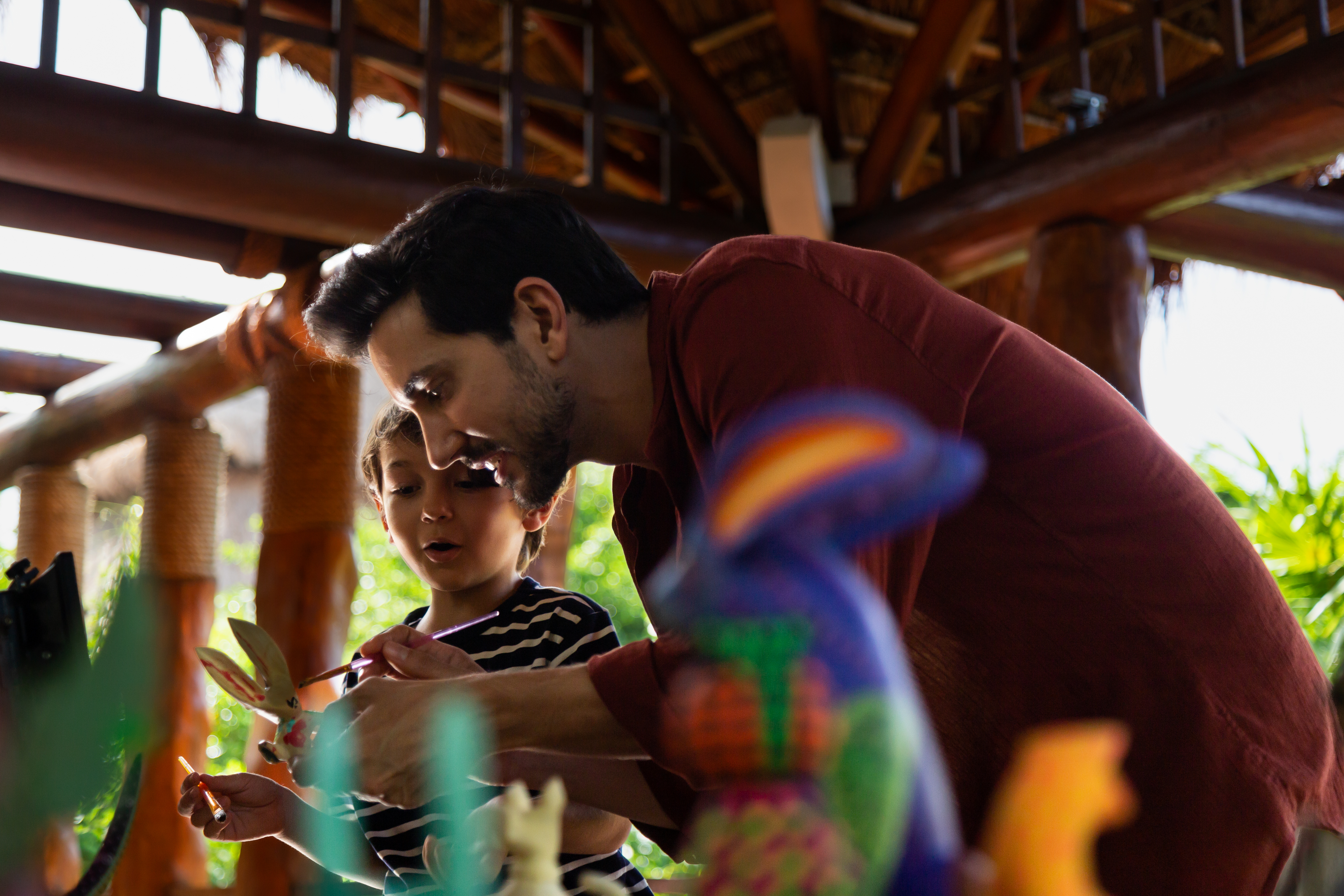 a man and child playing with toys