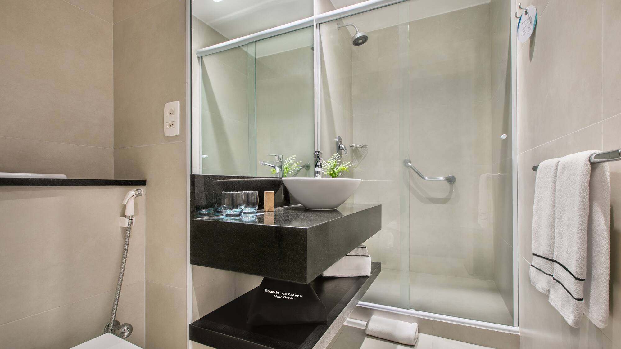 a bathroom with a glass shower door