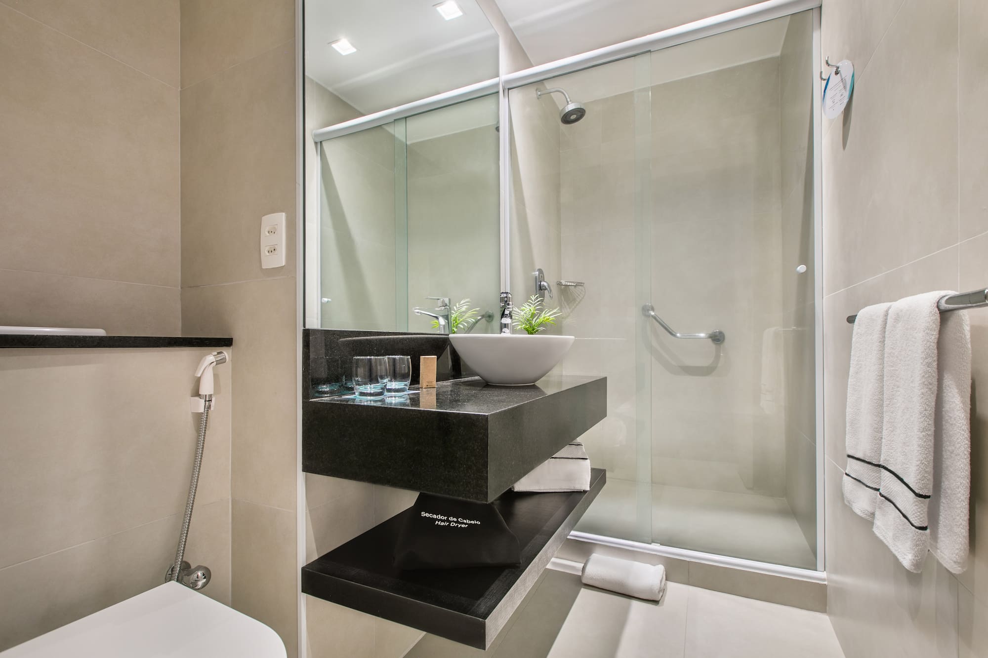 a bathroom with a glass shower door