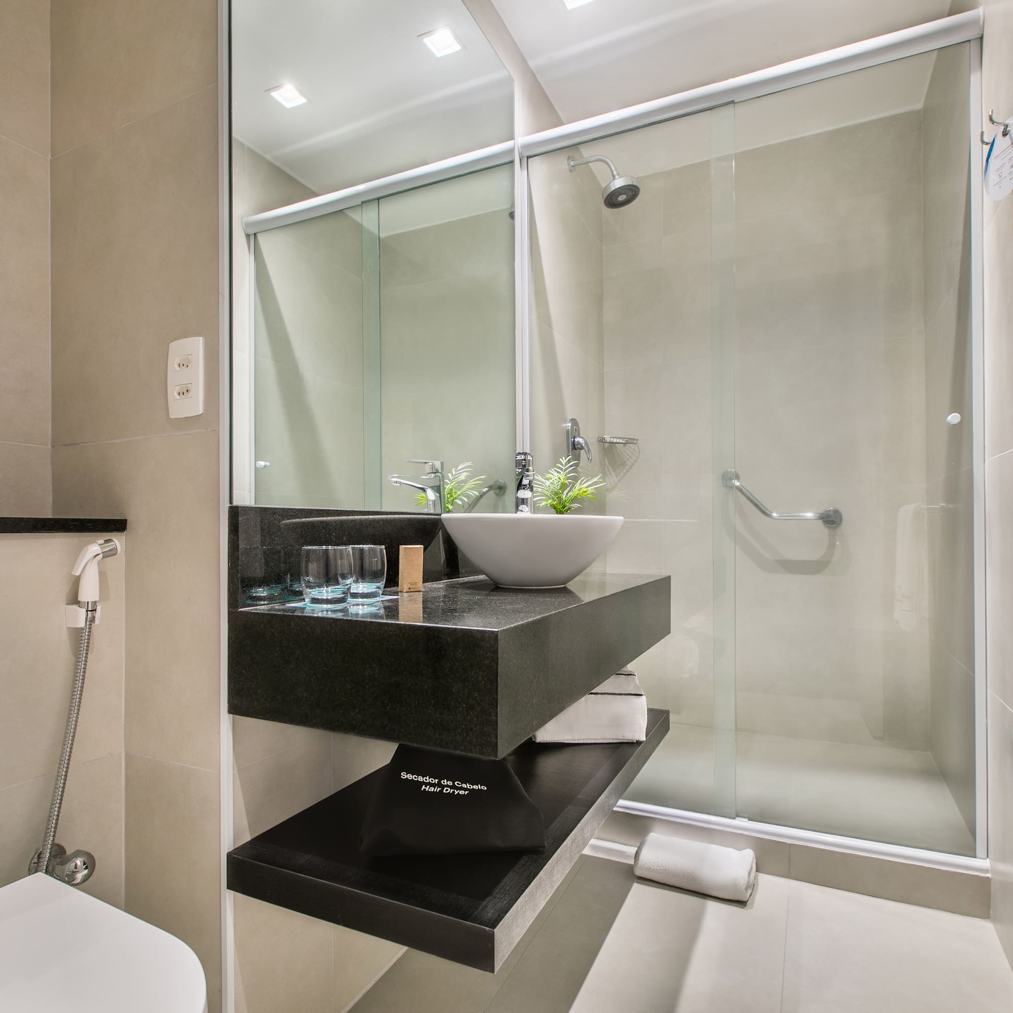 a bathroom with a glass shower door