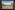Safari lodge balcony view of vast African savanna with scattered trees and hills.