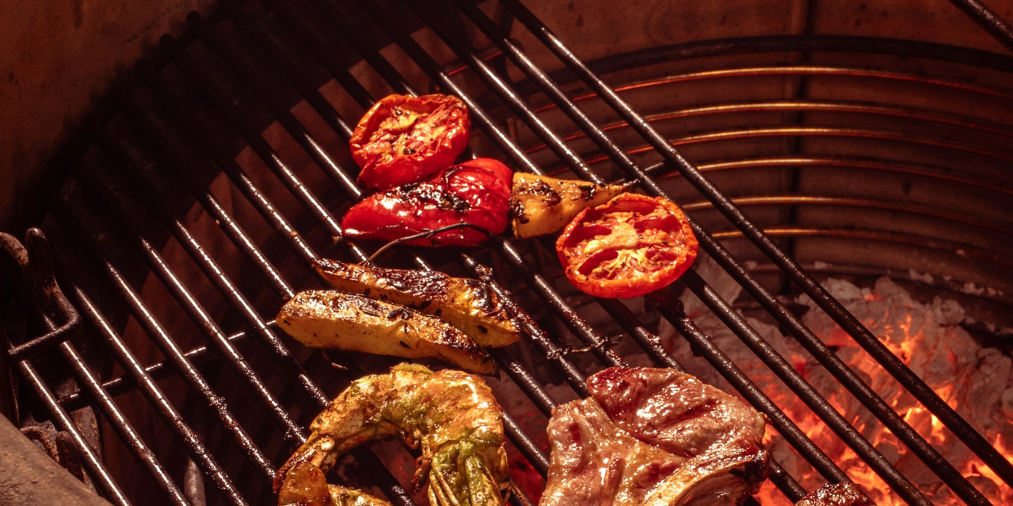 meat on a grill with flames