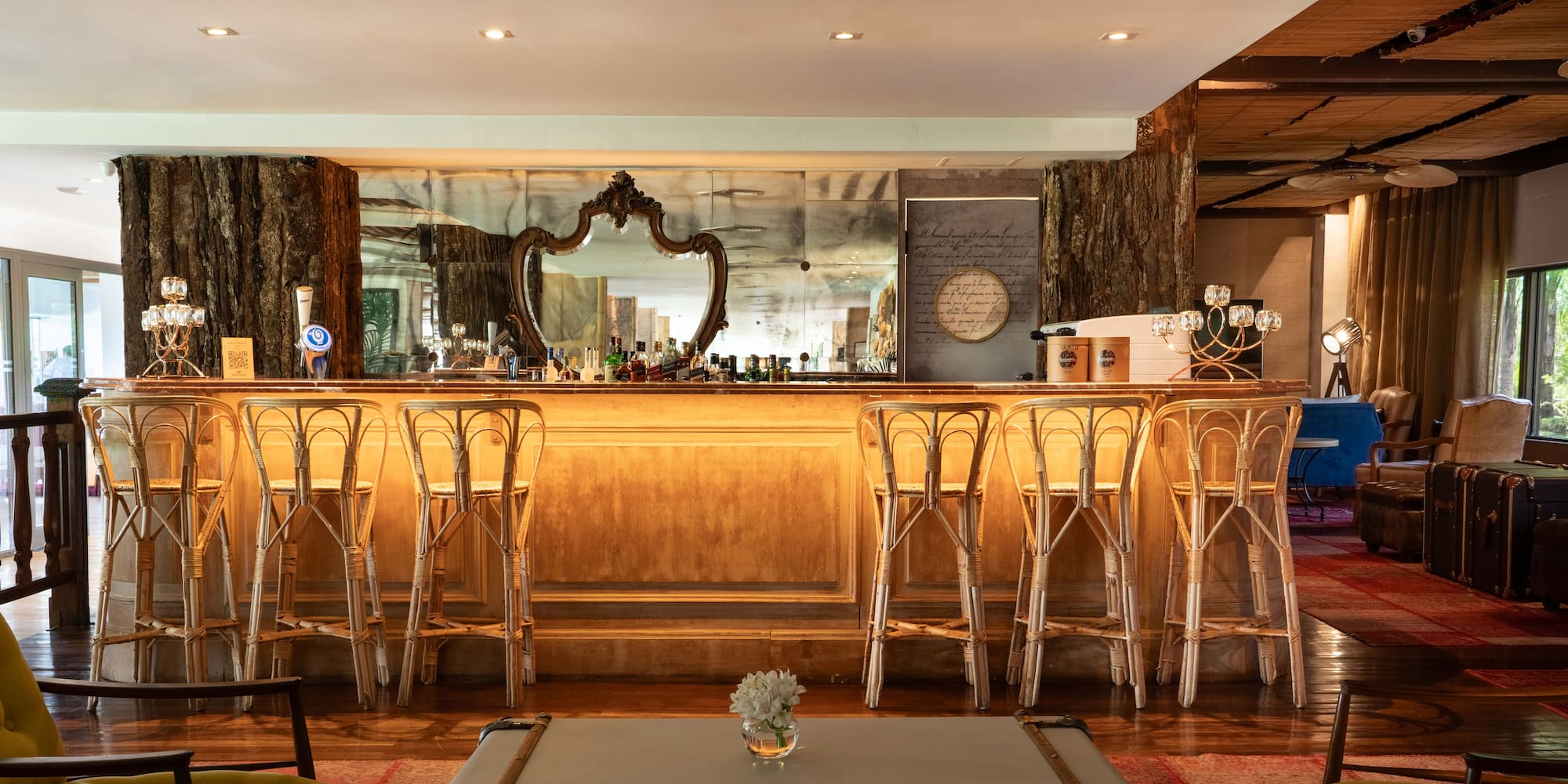 a bar with stools and a mirror