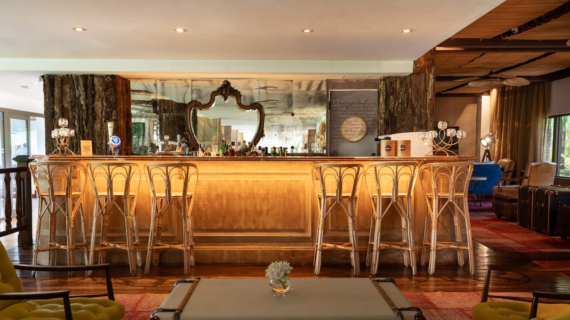 a bar with stools and a mirror