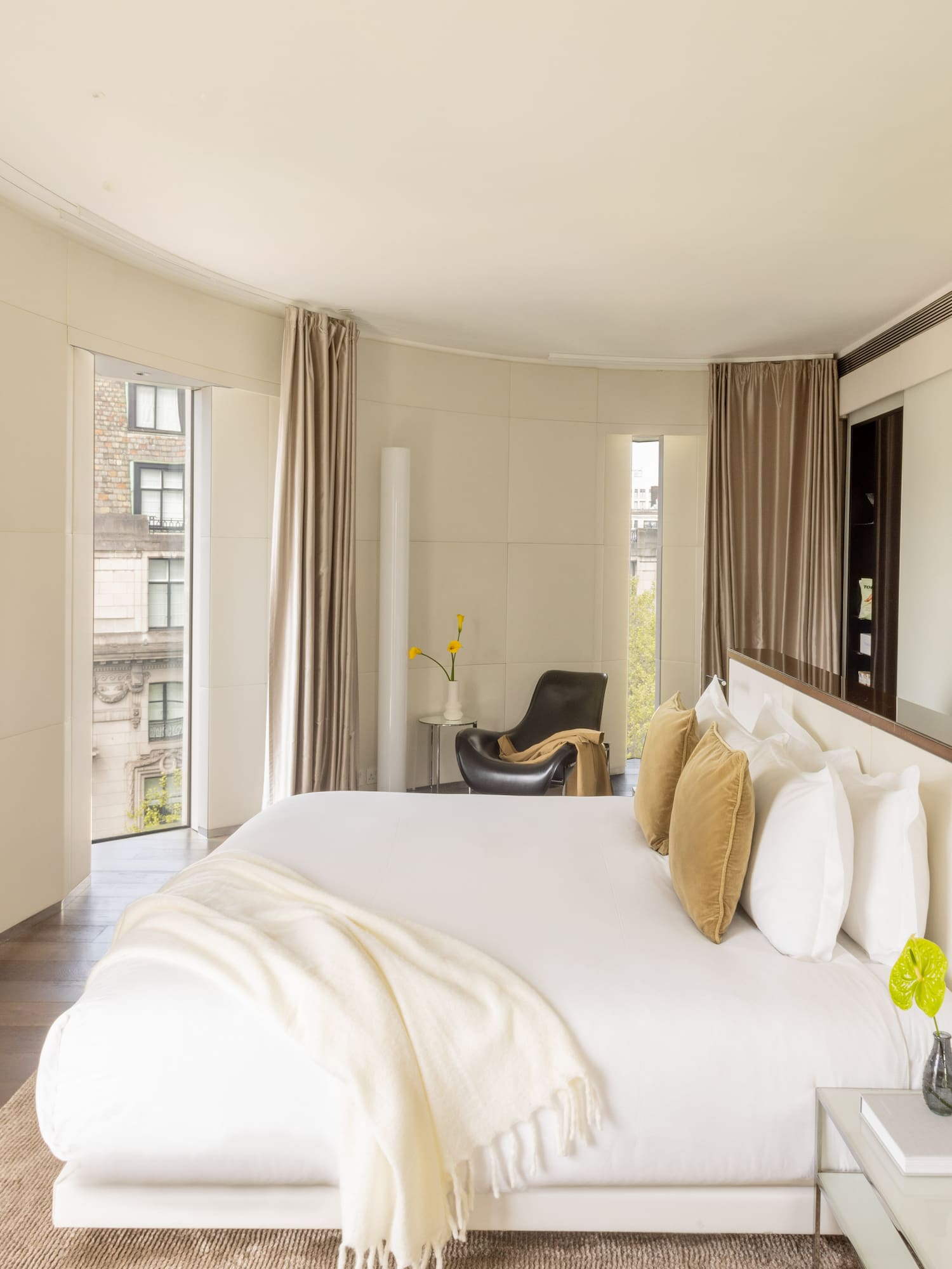 a bedroom with a large bed and a television