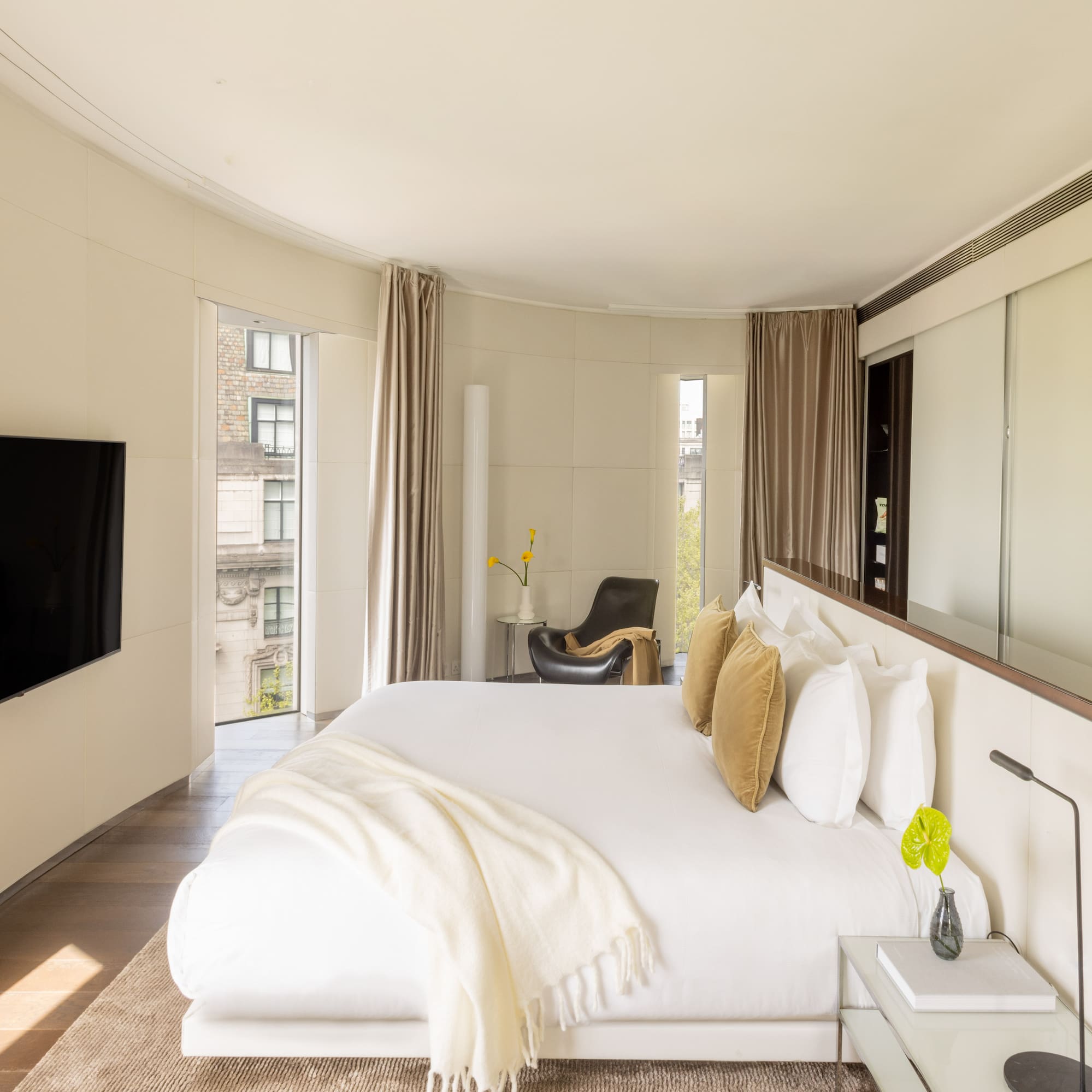 a bedroom with a large bed and a television