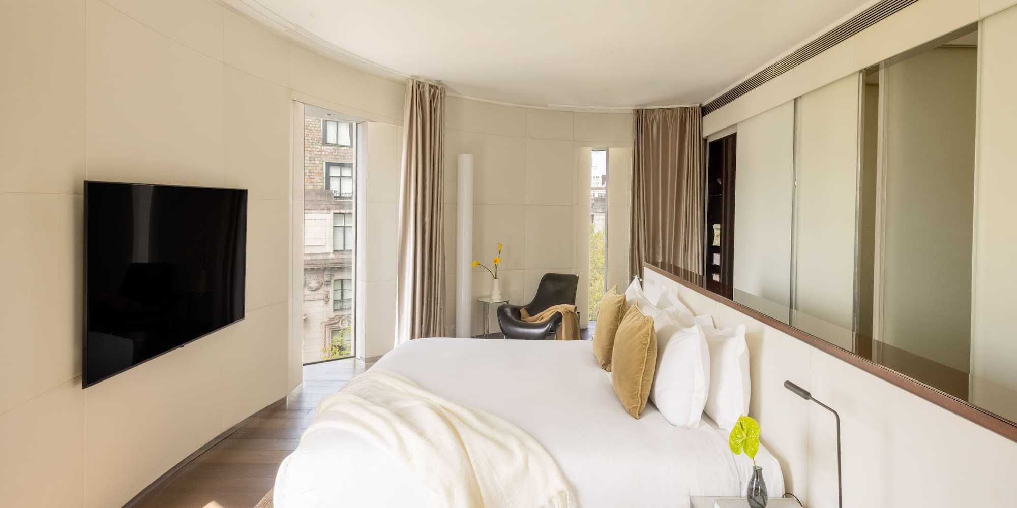 a bedroom with a large bed and a television