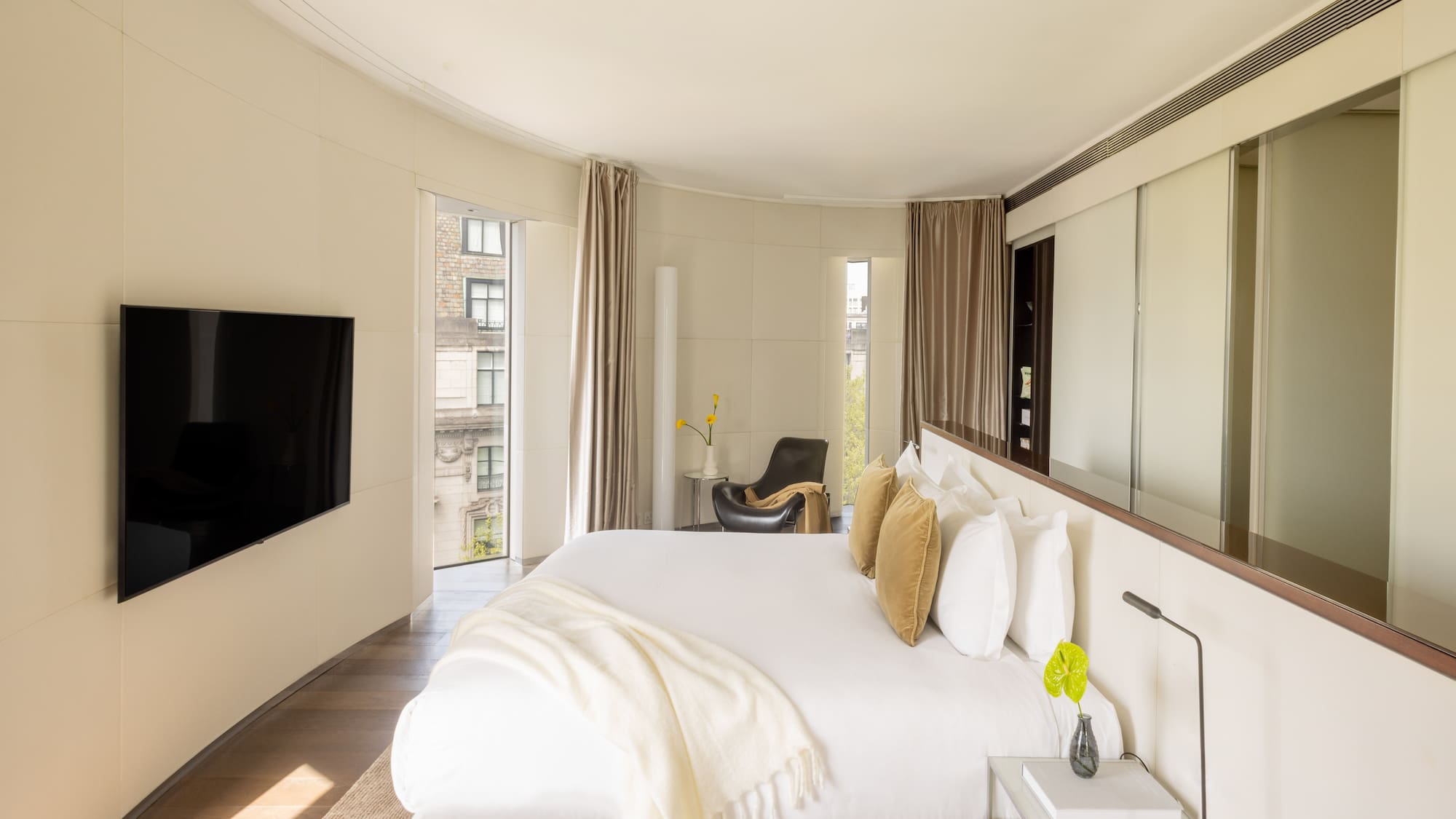 a bedroom with a large bed and a television