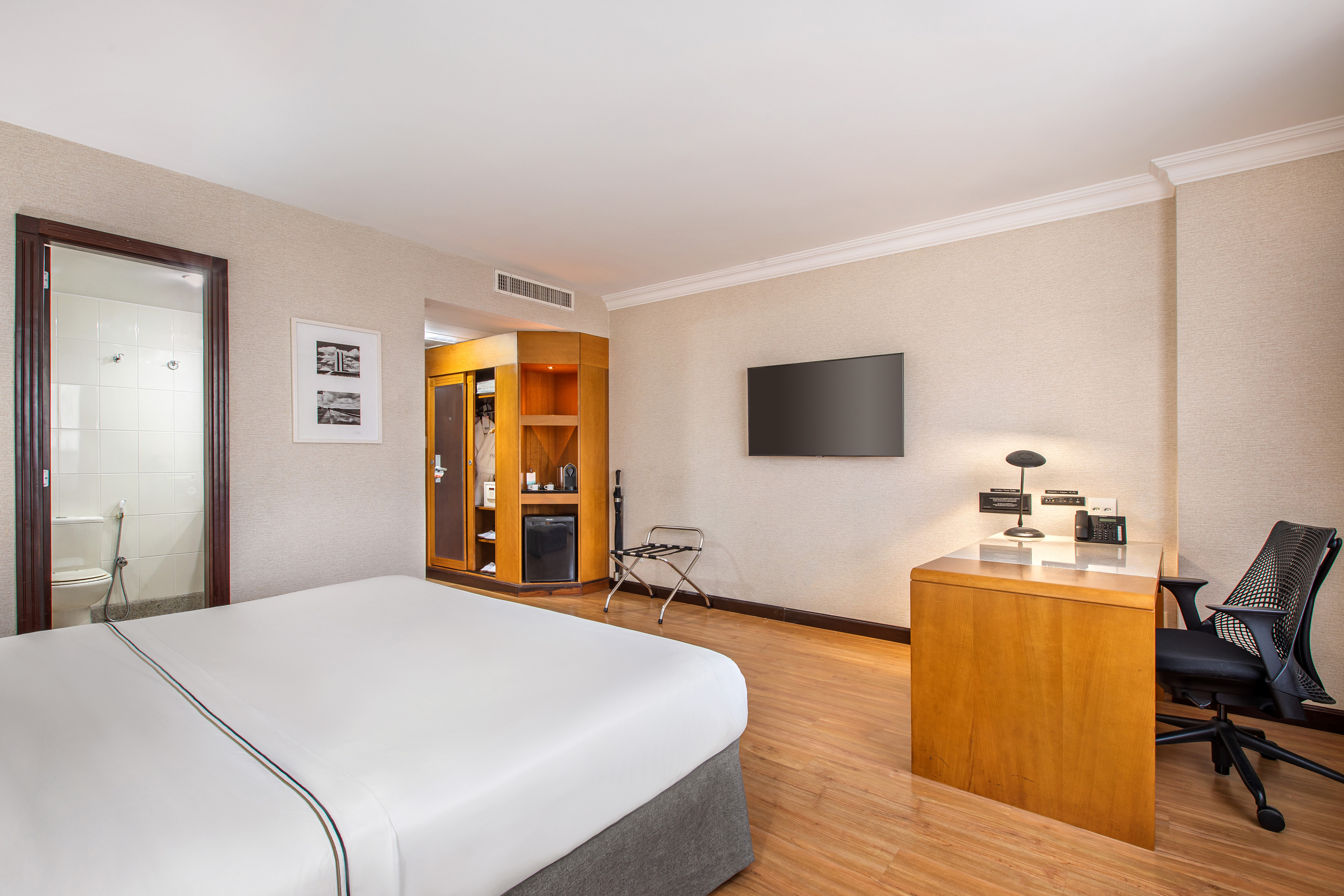 a room with a bed and a television