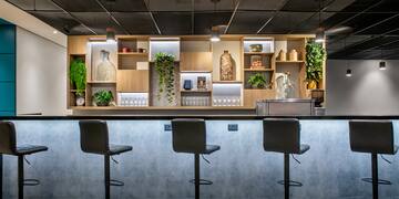 a bar with stools and shelves