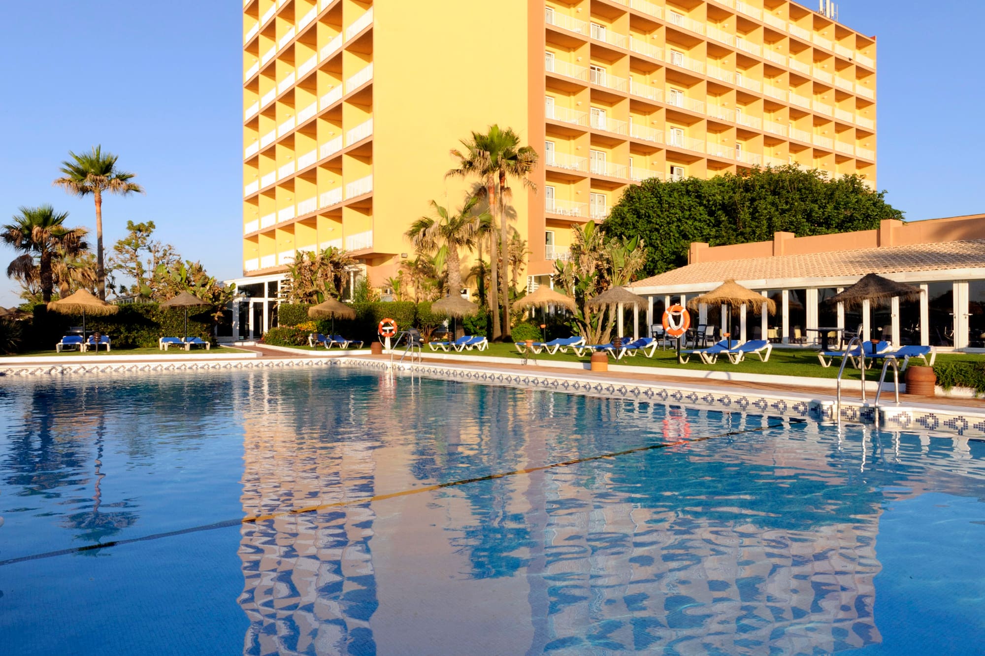 a large building with a pool in front of it.