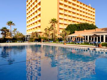 a large building with a pool in front of it.