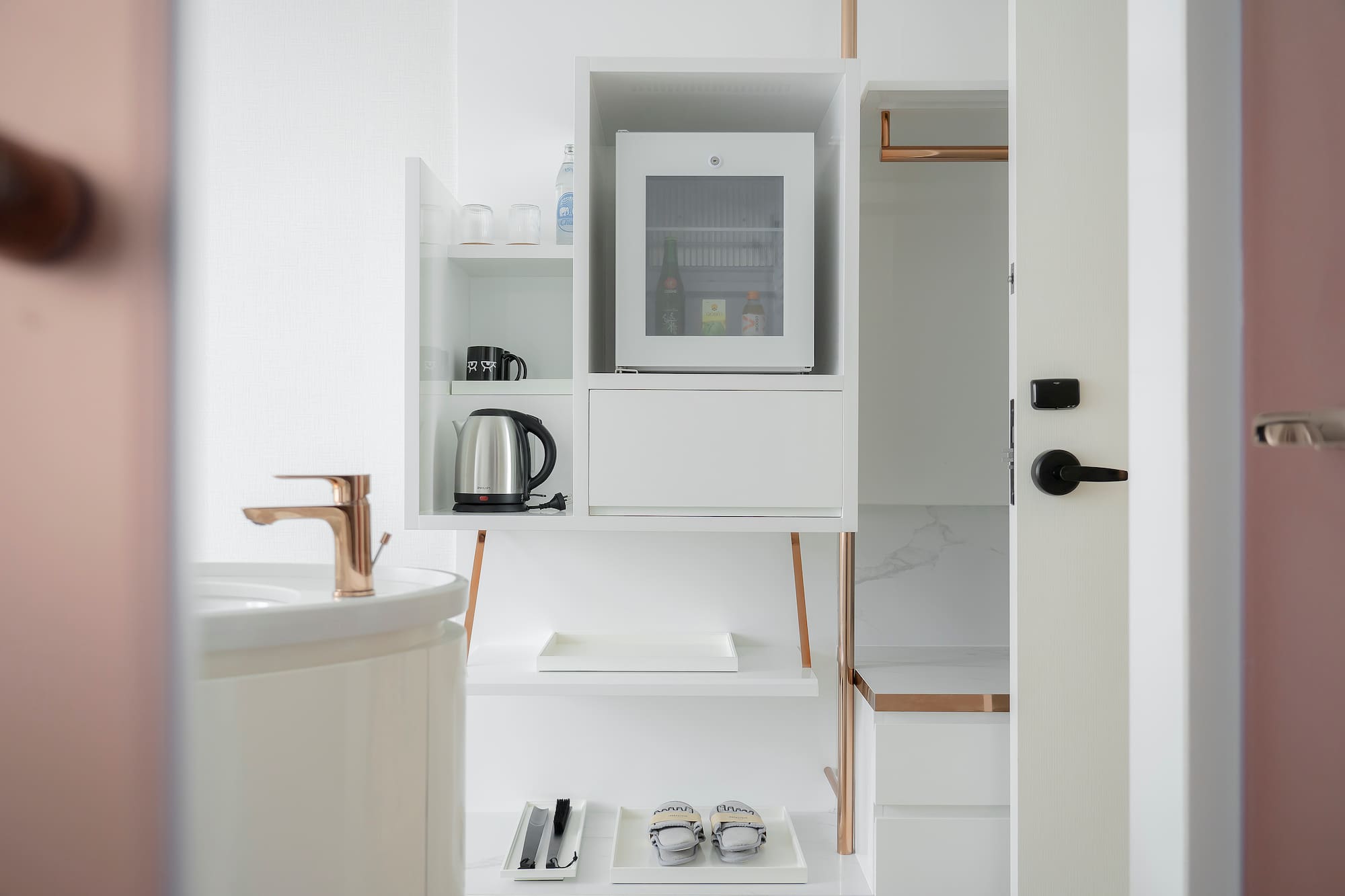 a white shelf with a microwave and a sink