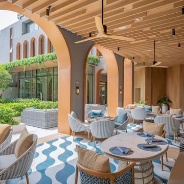 a patio with tables and chairs